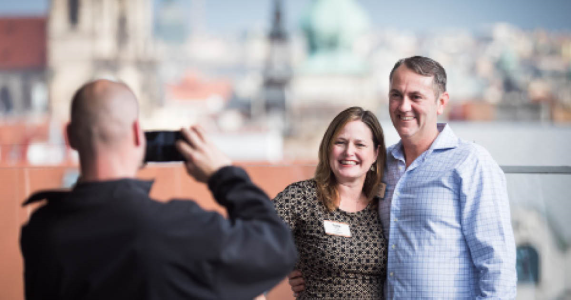 happy couple posing for photographer on incentive travel trip